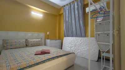 a bedroom with a bunk bed and a ladder at Kinta Riverfront Apartment Riverview Apartment in Ipoh