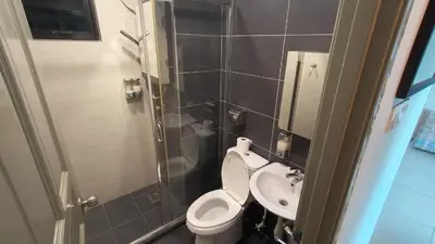 a small bathroom with a toilet and a sink at Kinta Riverfront Apartment Riverview Apartment in Ipoh