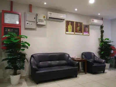 a waiting room with two leather chairs and a table at Amigo Hotel in Seri Iskandar