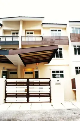 a building with a fence in front of it at Shamrock Seaview 11 Villa in Batu Ferringhi