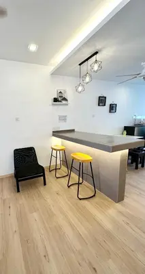 a kitchen with two tables and a counter in a room at Sakura 1 Homestay Kampar Landed in Kampar