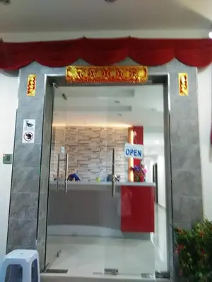 a door to a store with a sign that reads open at Thanks Hotel in Parit Buntar