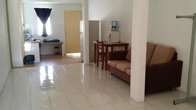 a living room with a couch and a table at The Simple Homestay in Simpang Pulai