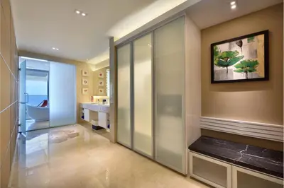 a hallway with a walk in shower and a bathroom at Lexis Suites Penang in Bayan Lepas