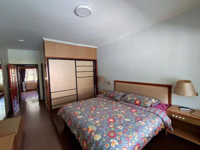 a bedroom with a bed and a lamp and a dresser at Mary Apt @ Equatorial Hill Resort in Cameron Highlands