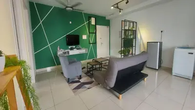 a living room with a couch and a desk with a computer at Merlene Suites at Mansion One Formerly know as Mansion One Suites in George Town