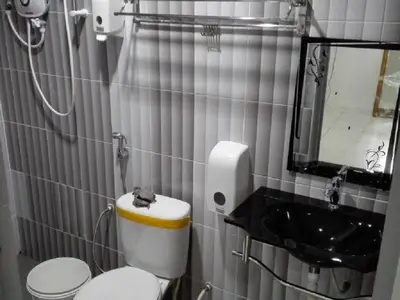 a small bathroom with a toilet and a sink at Pangkor Home Sea Village in Pangkor