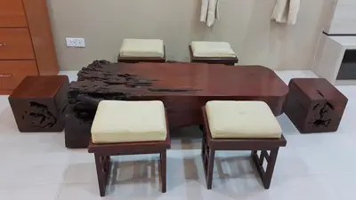 a wooden table with four chairs in a room at Rose Apartment Kea Farm in Cameron Highlands