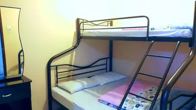 two bunk beds in a room with a mirror at Rose Apartment Kea Farm in Cameron Highlands