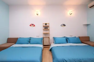 a room with two beds and a couch at 118 Residences by Travovo in George Town
