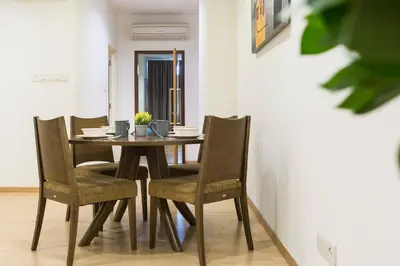 a dining room with a wooden table and chairs at 118 Residences by Travovo in George Town