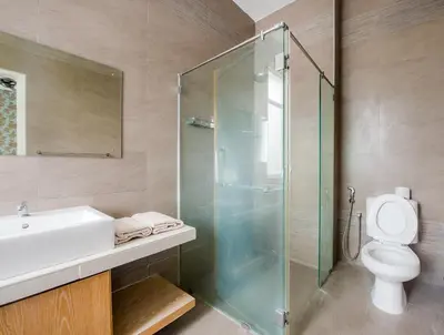 a bathroom with a shower and a sink and a toilet at New Shamrock Beach Villas Seaview in Batu Ferringhi