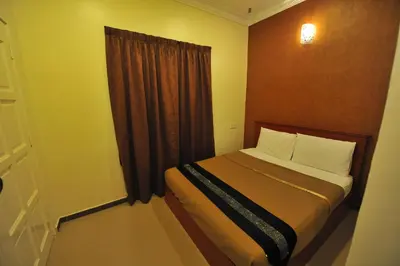 a small bedroom with a bed and a window at Gurney Inn in George Town