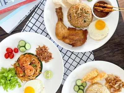 three white plates of food on a table at Iconic Hotel in Bukit Mertajam