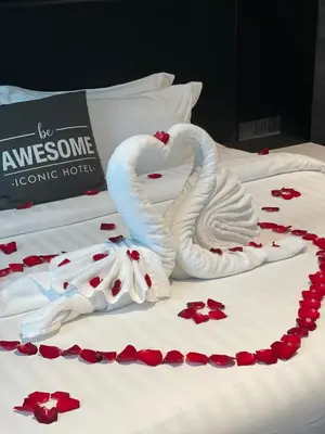 a bed with two swans made out of red roses at Iconic Hotel in Bukit Mertajam