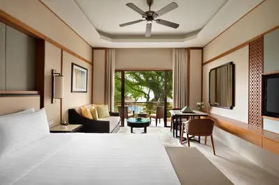 a bedroom with a bed and a living room at Shangri-La Rasa Sayang, Penang in Batu Ferringhi