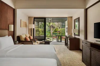 a hotel room with a bed and a television at Shangri-La Rasa Sayang, Penang in Batu Ferringhi