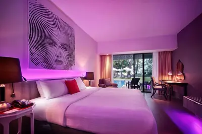 a bedroom with a large bed with purple lighting at Hard Rock Hotel Penang in Batu Ferringhi