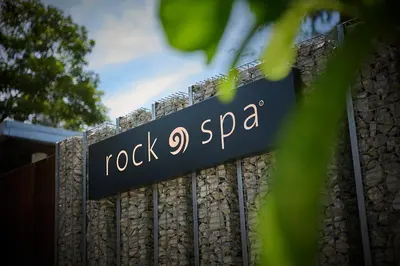 a sign for rock spa on a fence at Hard Rock Hotel Penang in Batu Ferringhi