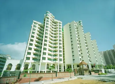 two tall white apartment buildings in a city at Century Bay Private Residences in Bayan Lepas