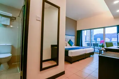 a hotel room with a bed and a bathroom at Flamingo Hotel by the Beach, Penang in George Town