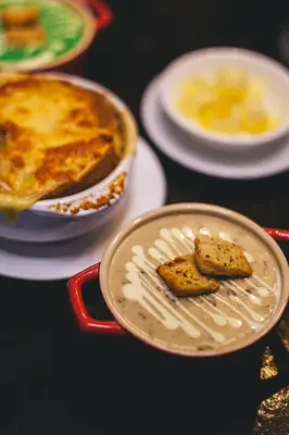 a table topped with plates of food with bread at The Smokehouse Hotel & Restaurant Cameron Highlands in Cameron Highlands