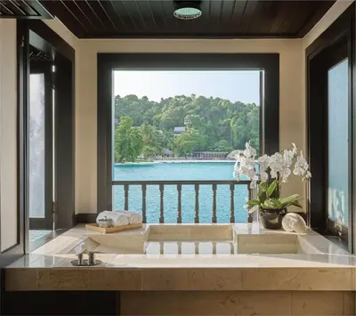 a bathroom with a large window with a view of the water at Pangkor Laut Resort - Small Luxury Hotels of the World in Pangkor