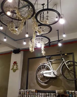 a bike hanging from a ceiling with chandeliers at Sweet Homestay Penang in Bayan Lepas