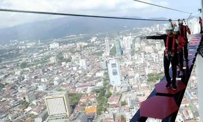 a person standing on a zip line over a city at Sweet Homestay Penang in Bayan Lepas