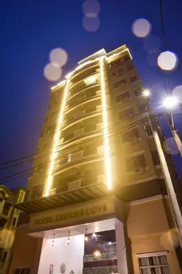 a tall building with lights on top of it at Leisure Cove Hotel and Apartments in George Town