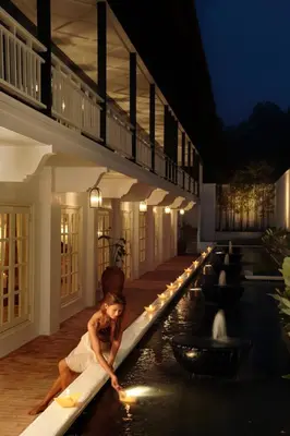 a woman laying on a swimming pool in a building at Cameron Highlands Resort - Small Luxury Hotels of the World in Cameron Highlands