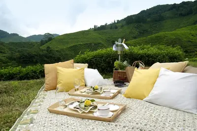 a picnic table with two plates of food on it at Cameron Highlands Resort - Small Luxury Hotels of the World in Cameron Highlands
