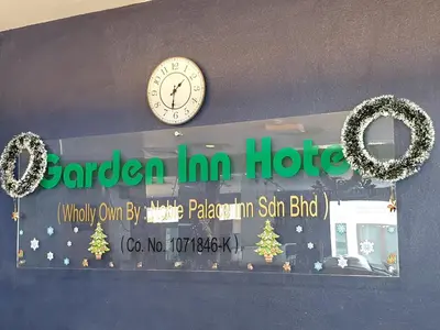 a clock on a wall with christmas wreaths at Garden Inn, Penang in George Town