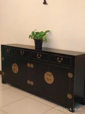 a black cabinet with a potted plant on top of it at Marina Oriental Hotel in Butterworth