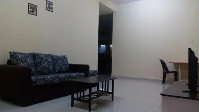 a living room with a couch and a table at Taiping Valuable Homestay in Taiping