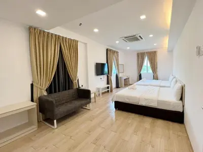 a bedroom with a bed and a couch in it at Vvip Hotel in Hutan Melintang