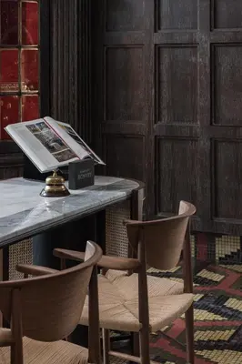 two chairs sitting next to a table with a magazine at Macalister Mansion, a Member of Design Hotels in George Town