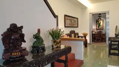 a living room with some statues on a table at MY CHINAMAN'S HOME II in George Town