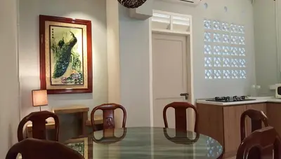 a dining room with a glass table and chairs at MY CHINAMAN'S HOME II in George Town