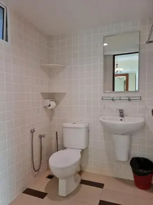a bathroom with a toilet and a sink at Aloka Seaview Apartment in Batu Ferringhi