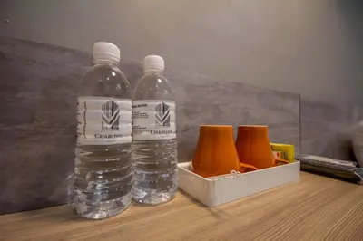 two bottles of water and a box of orange slices at Chariton Hotel Alma in Bukit Mertajam