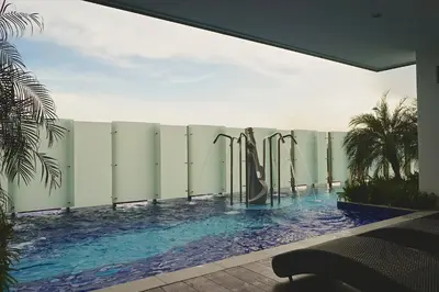 a swimming pool next to a fence with a swimming pool at The Majestic Ipoh by The Osborne in Ipoh