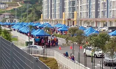 a group of blue tents in a parking lot at Strawberry Homestay in Cameron Highlands