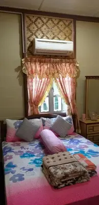 a bedroom with a large bed with a canopy at Teratak Opah Kamunting in Taiping