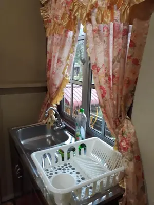 a sink in a kitchen with a window at Teratak Opah Kamunting in Taiping