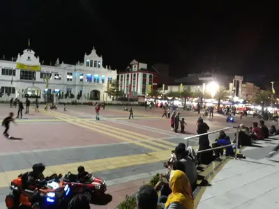 a group of people sitting on motorcycles in a square at night at Teratak Opah Kamunting in Taiping