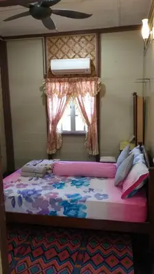 a bedroom with a bed with a window and a bedspread at Teratak Opah Kamunting in Taiping