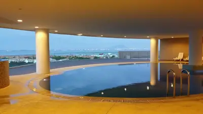 a swimming pool in a building with a view of the ocean at 118 Suite in George Town