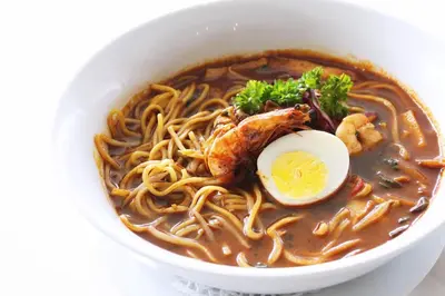 a bowl of ramen with an egg on top at Meru Suites at Meru Valley Resort in Ipoh