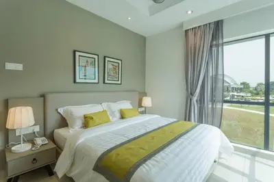 a bedroom with a bed and a large window at Meru Suites at Meru Valley Resort in Ipoh